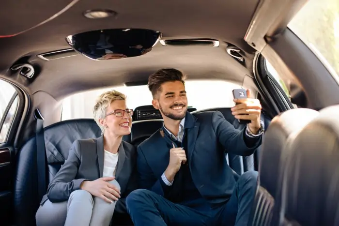 Happy couple taking a selfie inside a luxury limousine during a comfortable ride with Barrie limo service